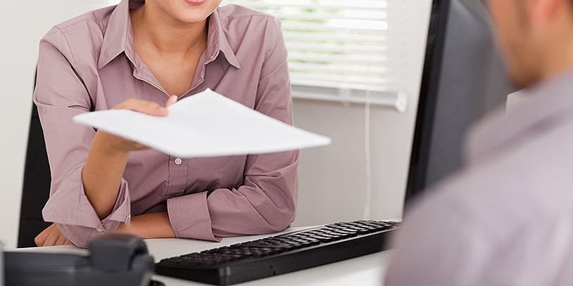 A businesswoman is presenting a contract to a customer